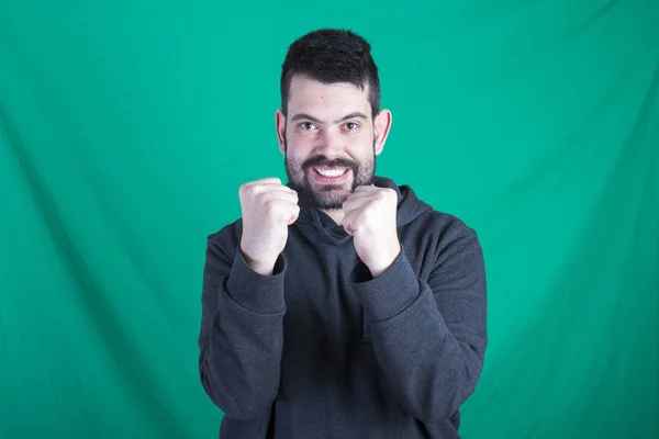 Portrait Happy Man Green Background Showing His Fists — Stock Photo, Image