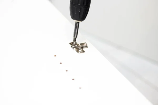 Carpenter Using Screwdriver Tool While Repairing White Cabinet Fixing Concept — Stock Photo, Image