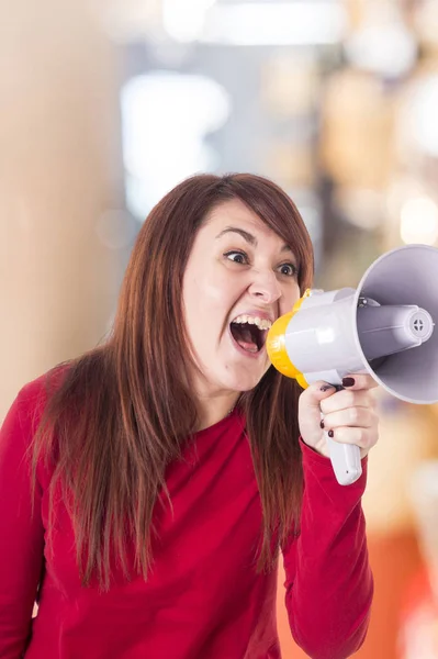 caucasian shouting woman screaming loud at megaphone