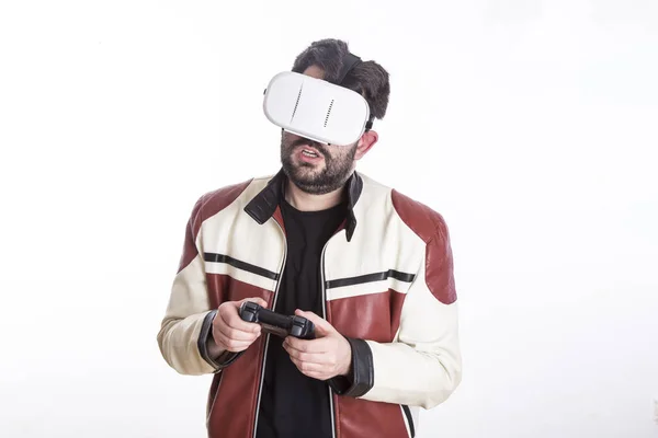 gamer man wearing vr glasses in white studio and using game joystick