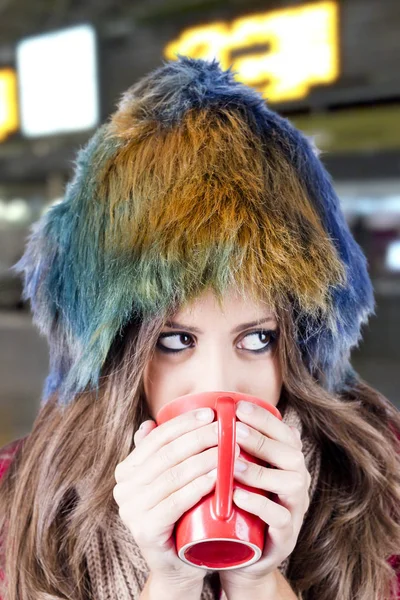 Stylish Girl Multicolored Fur Hat Holding Red Cup — Stock Photo, Image