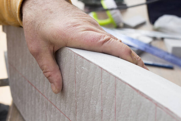 cropped image of man holding boat model 