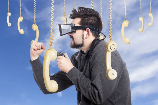 人使用 玩游戏操纵杆反对天空与挂老式电话手机 — 图库照片