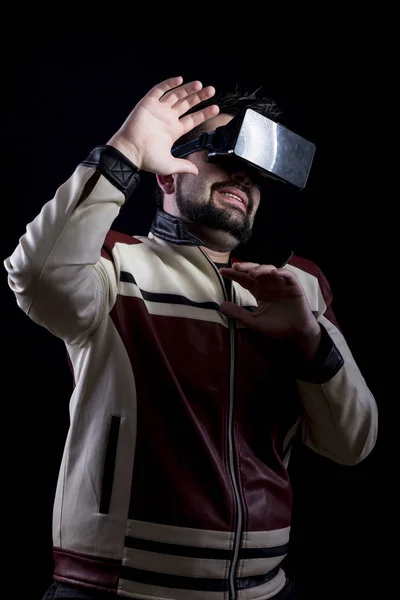 scared man wearing VR glasses in dark studio