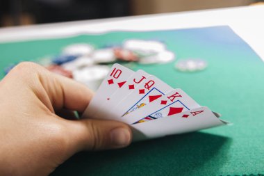 yeşil tablo casino kartları tutan el kısmi görünümünü
