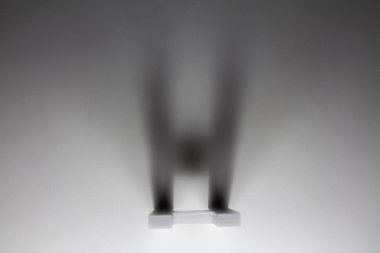 Alfabe harf gölge H ile gri ışık yüzey