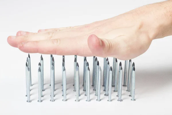 Hand Touching Steel Spikes Pins — Stock Photo, Image