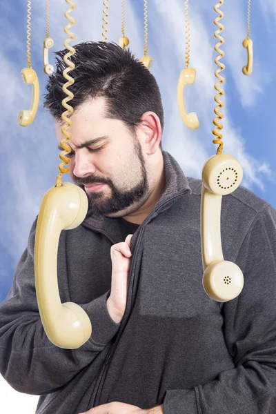 sad man against blue sky surrounded with hanging telephones