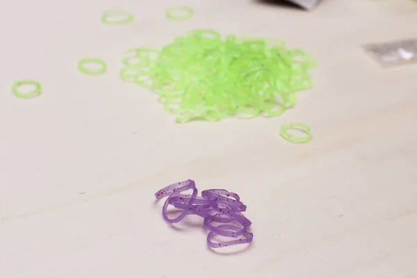 violet and green rubber bracelet bands on table