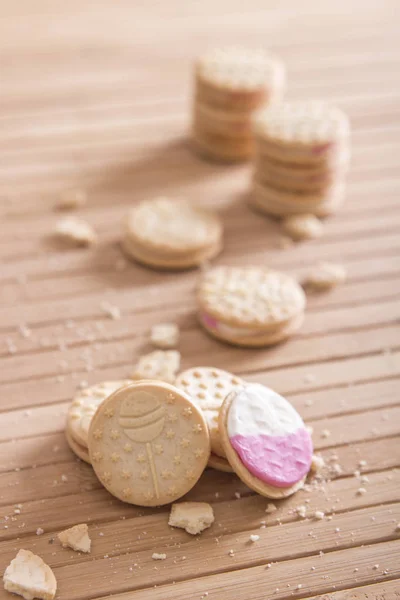 appetizing cookies with crumbs on wooden table surface