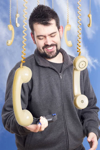 Uśmiechnięty Mężczyzna Stojący Pod Wiszącą Telefony — Zdjęcie stockowe