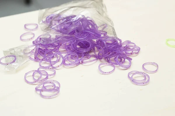 violet rubber bracelet bands on white table