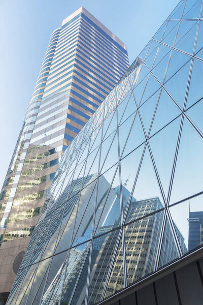Reflection of urban skyline on modern office building