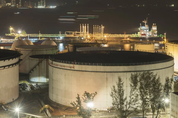 oil tanker and oil tank in port at night
