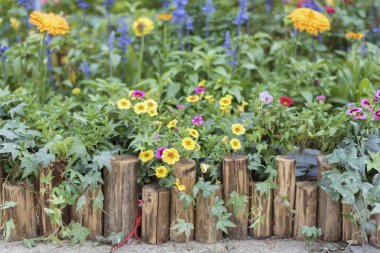 Wooden fence in beautiful backyard flower garden clipart
