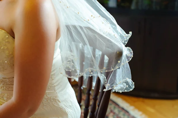 The wedding veil, decorated with beads. Light transparent cloth.