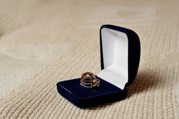 Beautiful wedding rings in blue jewelry box.