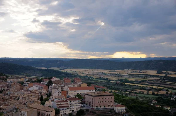 View from Cardona Castle. The sky is clouded over. The ray of the sun breaks through the cloud. Summer. Catalonia, Spain.