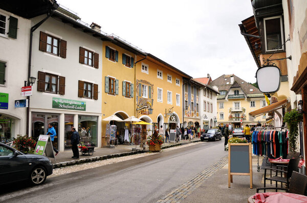 MITTENWALD, GERMANY - AUGUST 13, 2014: Street with houses decorated with colorful painting in the old town. Beautiful painted traditional houses, the famous old facades with historic murals.