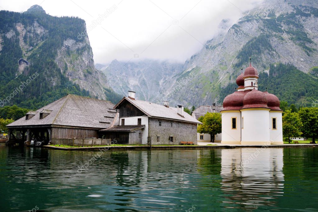 St. Bartholomew's church on Konigssee.  View from the water against the background of the mountains. Bavaria, Germany.