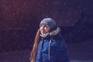 Kış geceleri lamba altında gülümseyen kız