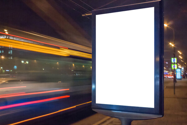 Blank lightbox at night with car lights in motion blur
