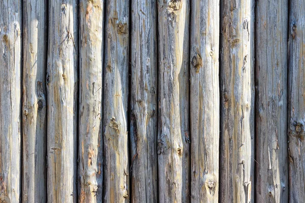 Background of ancient fence from trunks of trees — Stock Photo, Image