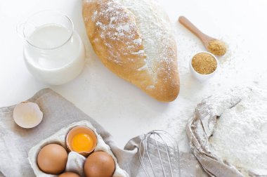 Ev yapımı ekmek için malzemeler. Yumurta, süt, un. Beyaz arka plan, yan görünüm