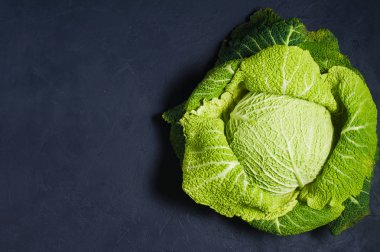 Savoy lahana. Koyu arka plan, üstten görünüm, metin için yer