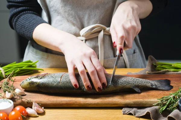 厨师在木制的切菜板上切了生鳟鱼 成分迷迭香 西红柿 黑色背景 侧视图 — 图库照片