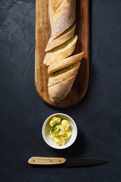 Sliced French Baguette Butter Sprig Rosemary Wooden Chopping Board Black — Stock Photo, Image
