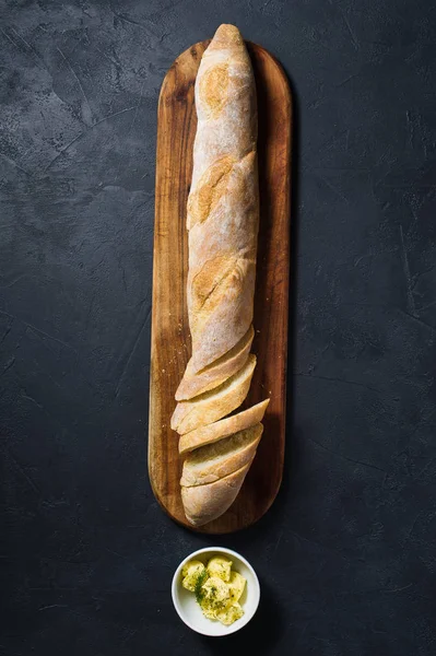 Sliced French Baguette Butter Sprig Rosemary Wooden Chopping Board Black — Stock Photo, Image