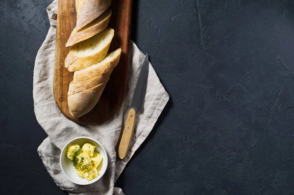 Sliced French Baguette Butter Sprig Rosemary Wooden Chopping Board Black — Stock Photo, Image