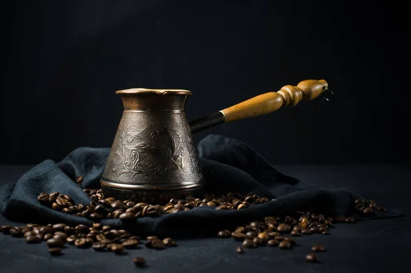 Turkish coffee in Turkey, coffee beans. Black background, side view, space for text