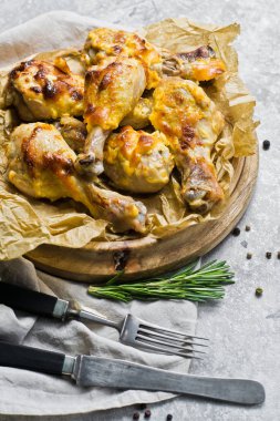 Kızarmış tavuk budu kaydıraklı tepsi. Gri arka plan, üstten görünüm.