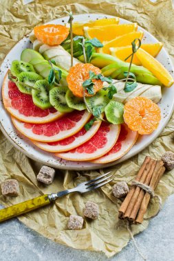Karışık meyve bir plaka üzerinde restoran. Greyfurt, mandalina, kı