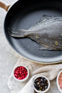 Pan çiğ yaldızlı pisibalığı. Gri arka plan, üstten görünüm.