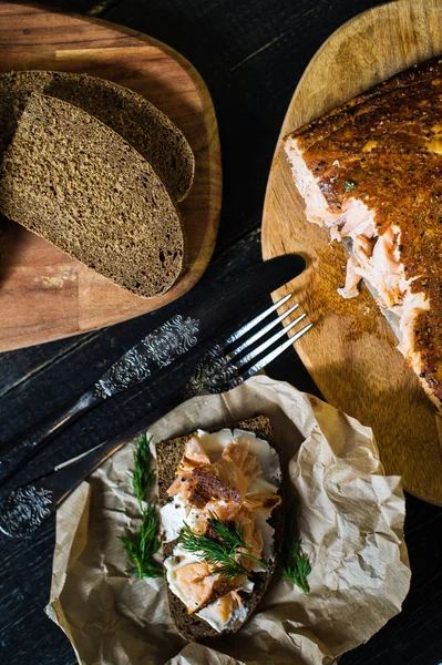 Скандинавский сэндвич с копченым лососиным филе на черном хлебе с мягким сыром — стоковое фото