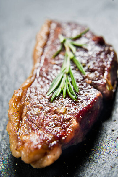 Steak of marbled beef black Angus roast rear. Black background, top view