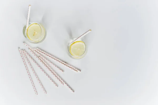 Glass of clear water with lemon and straw. — Stock Photo, Image