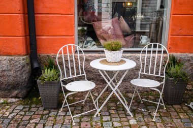 Masa ve iki beyaz sandalye sokak kafesi. Porvoo, Finlandiya