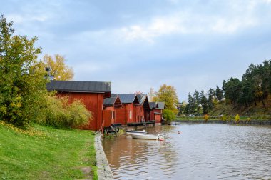 The granite embankment with red houses and barns. White bill boa
