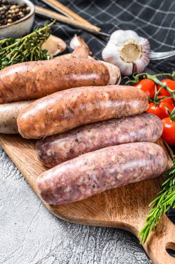 Baharatlı taze domuz eti, sığır eti ve tavuk sosisi. Gri arka plan. Üst görünüm.