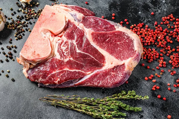 Raw fresh cross cut beef shank, leg. Black background. Top view.