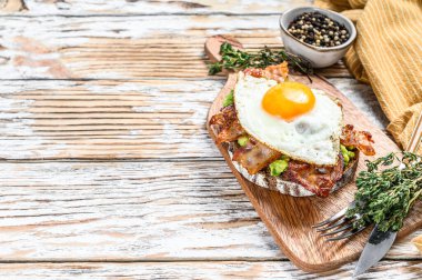 Avokadolu tost, kızarmış pastırma ve yumurta. Beyaz ahşap arka plan. Üst Manzara. Boşluğu kopyala.
