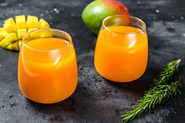 Refreshing mango juice in a glass. Black background. Top view. - Stock  Image - Everypixel
