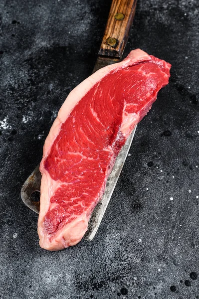 Raw marbled beef steak. black Angus meat. Black background. Top view.