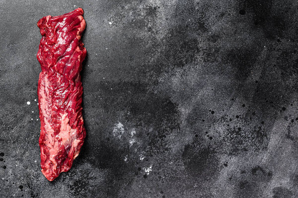 Raw top blade, Denver steak. Black background. Top view. Copy space.