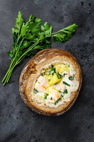 Finnish Creamy fish soup with salmon, trout, potatoes served in bread. Black background, top view — Stock Image Finnish Creamy Fish Soup Salmon Trout Potatoes Served Bread Black Royalty Free Stock Images