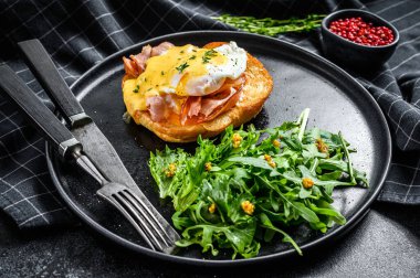 Pastırmalı kahvaltı burgeri, Benedict yumurtası, brioche ekmeğine Hollandaise sosu. Siyah arka plan. Üst görünüm.